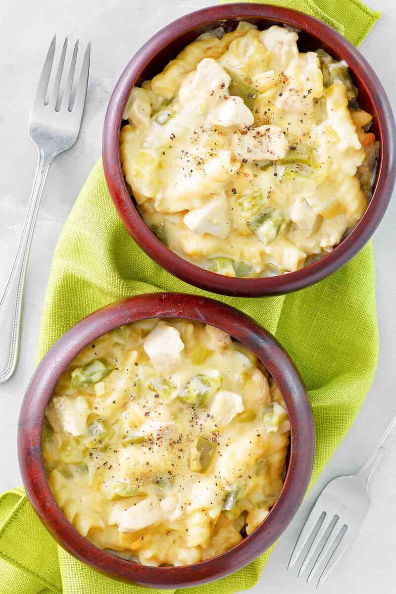 Two bowls of everyday chicken casserole and two forks.