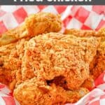 Homemade KFC fried chicken pieces on parchment paper in a basket.