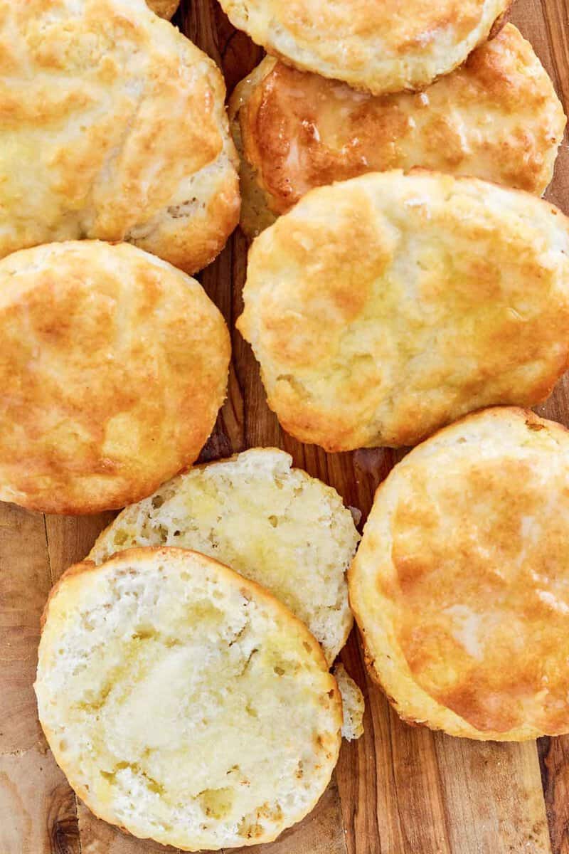 Copycat Popeyes biscuits and one cut in half with butter on it.