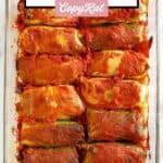 Stuffed cabbage rolls in a glass baking dish.