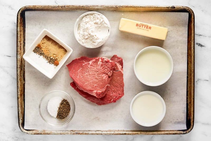 Copycat Texas Roadhouse chicken fried sirloin steak and gravy ingredients on a tray.