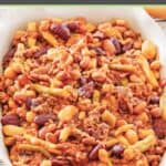 Crockpot calico beans in a serving dish on a table.