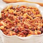 Crockpot calico beans in a ceramic serving dish.