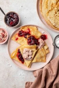 Copycat IHOP Swedish lingonberry crepes on a plate.