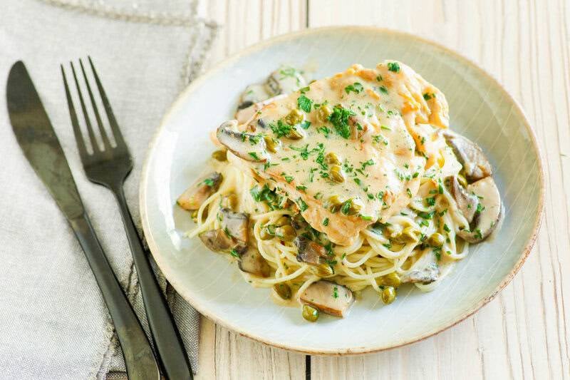 Copycat Cheesecake Factory chicken piccata served over angel hair pasta.