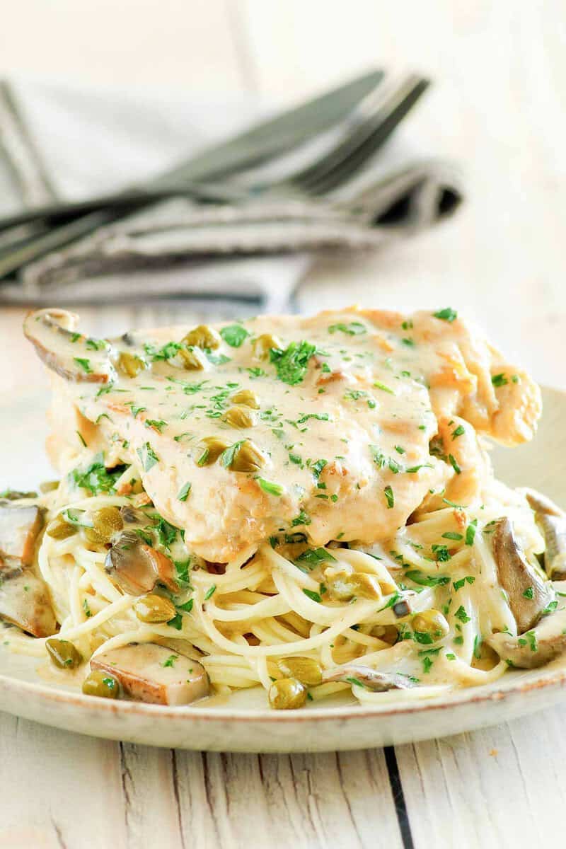 Copycat Cheesecake Factory chicken piccata over angel hair pasta.