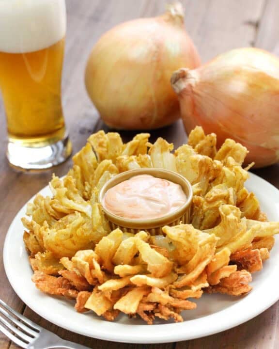 Copycat Chili's awesome blossom, large sweet onions, and a glass of beer.