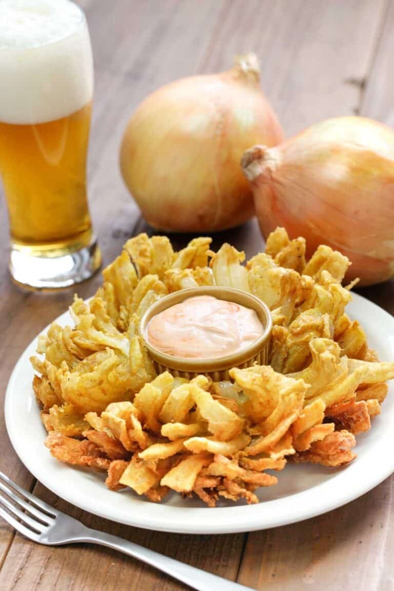 Copycat Chili's awesome blossom, large sweet onions, and a glass of beer.