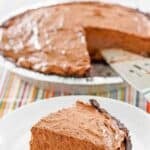 Homemade creamy chocolate pudding pie and a slice on a plate.