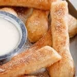 Homemade Domino's cinnastix and icing dipping sauce on a platter.