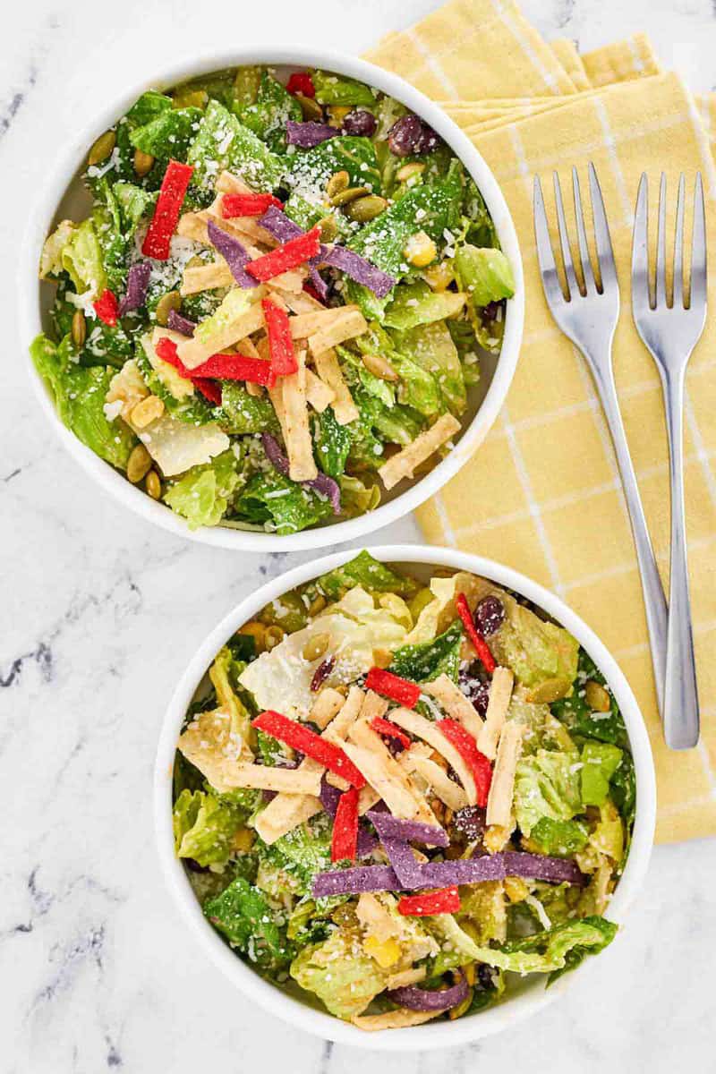 Copycat Houston's southwest caesar salad in bowls and forks next to them.