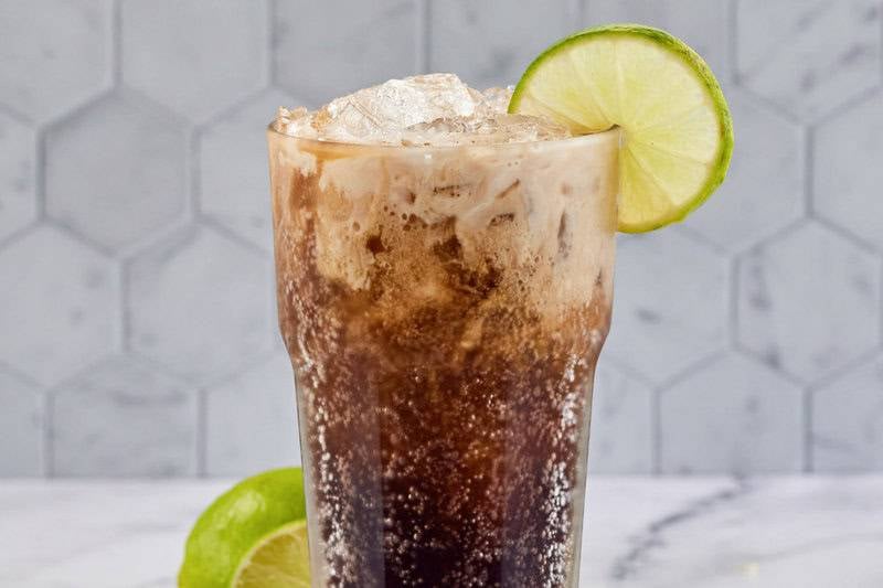 Copycat Sonic Dirty Dr. Pepper garnished with lime.