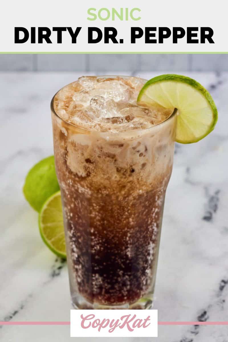 Homemade Sonic Dirty Dr. Pepper drink in a tall glass and a lime behind it.