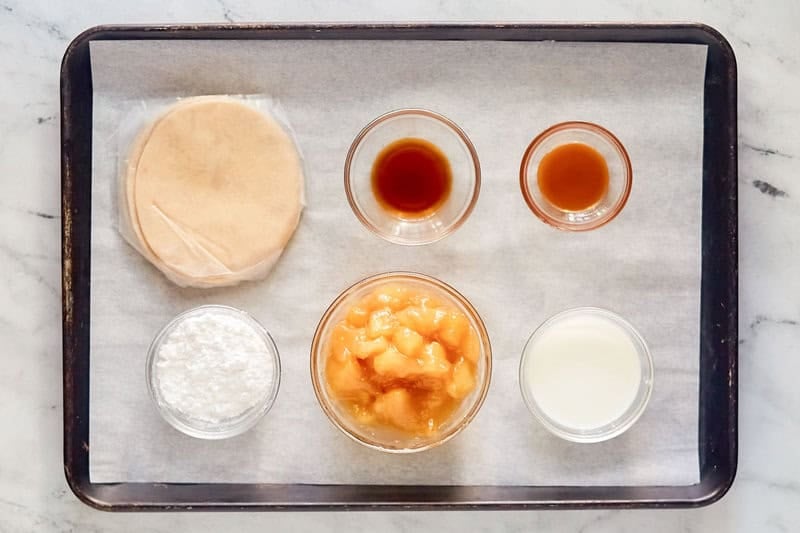 Copycat Taco Bell caramel apple empanada ingredients on a tray.