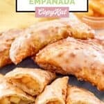 Homemade Taco Bell caramel apple empanadas whole and cut in half on a plate.