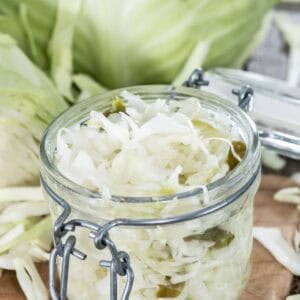 Homemade coleslaw that keeps in a jar and a head of cabbage.