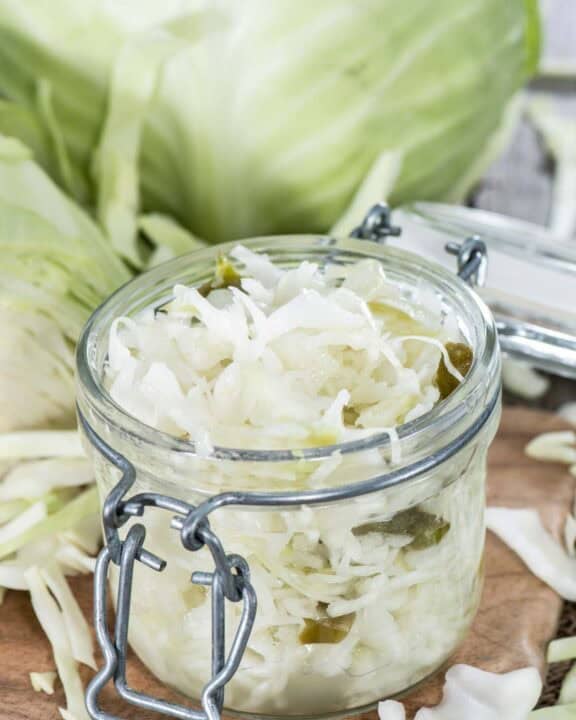 Homemade coleslaw that keeps in a jar and a head of cabbage.