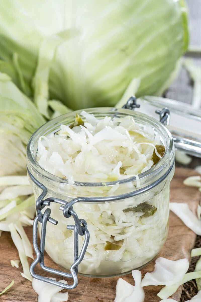 Homemade coleslaw that keeps in a jar and a head of cabbage.