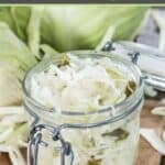 A jar of coleslaw that keeps, head of cabbage, and chopped cabbage.