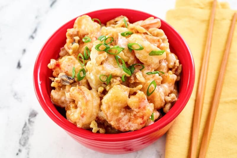 Copycat Panda Express honey walnut shrimp and chopsticks beside it.