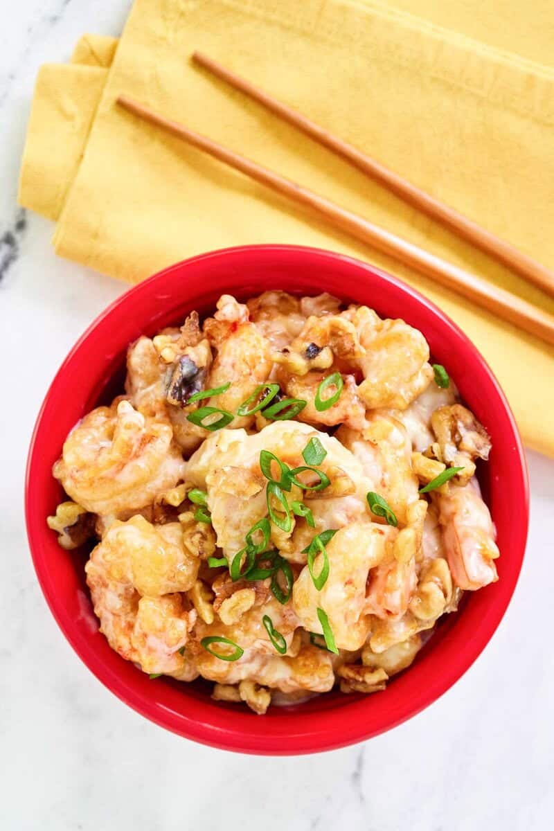 Copycat Panda Express honey walnut shrimp and chopsticks on a napkin.