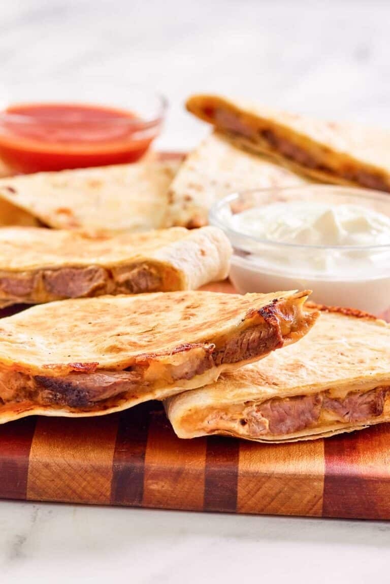 Copycat Taco Bell steak quesadilla on a wood serving board.