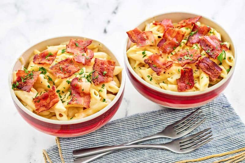 Two bowls of copycat Applebee's four cheese mac and cheese with bacon.