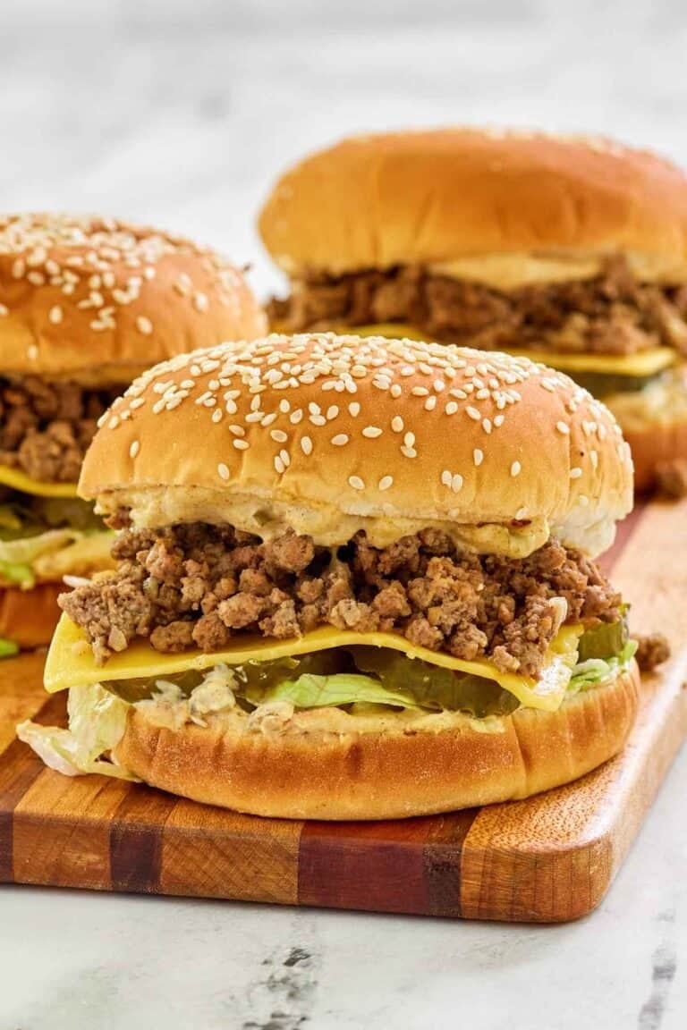 Big mac sloppy joes on a wood cutting board.