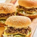 Three big mac sloppy joes on a wood serving platter.