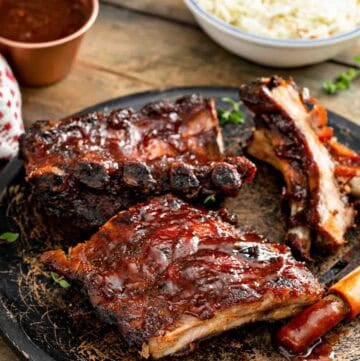 Copycat Claim Jumper bbq baby back ribis, bbq sauce, and coleslaw.