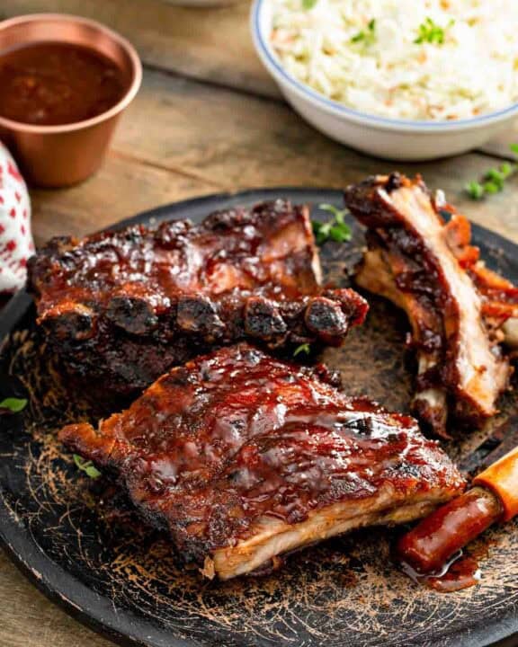 Copycat Claim Jumper bbq baby back ribis, bbq sauce, and coleslaw.