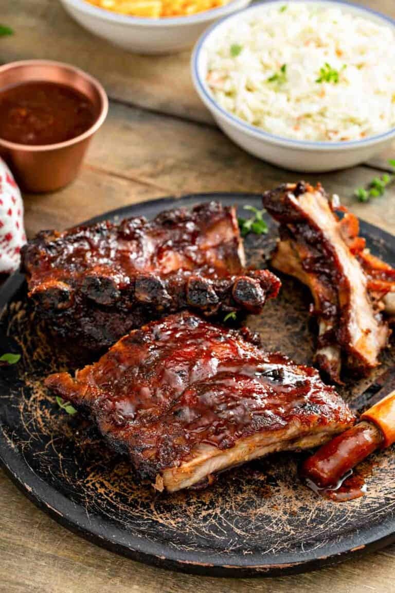 Copycat Claim Jumper bbq baby back ribis, bbq sauce, and coleslaw.