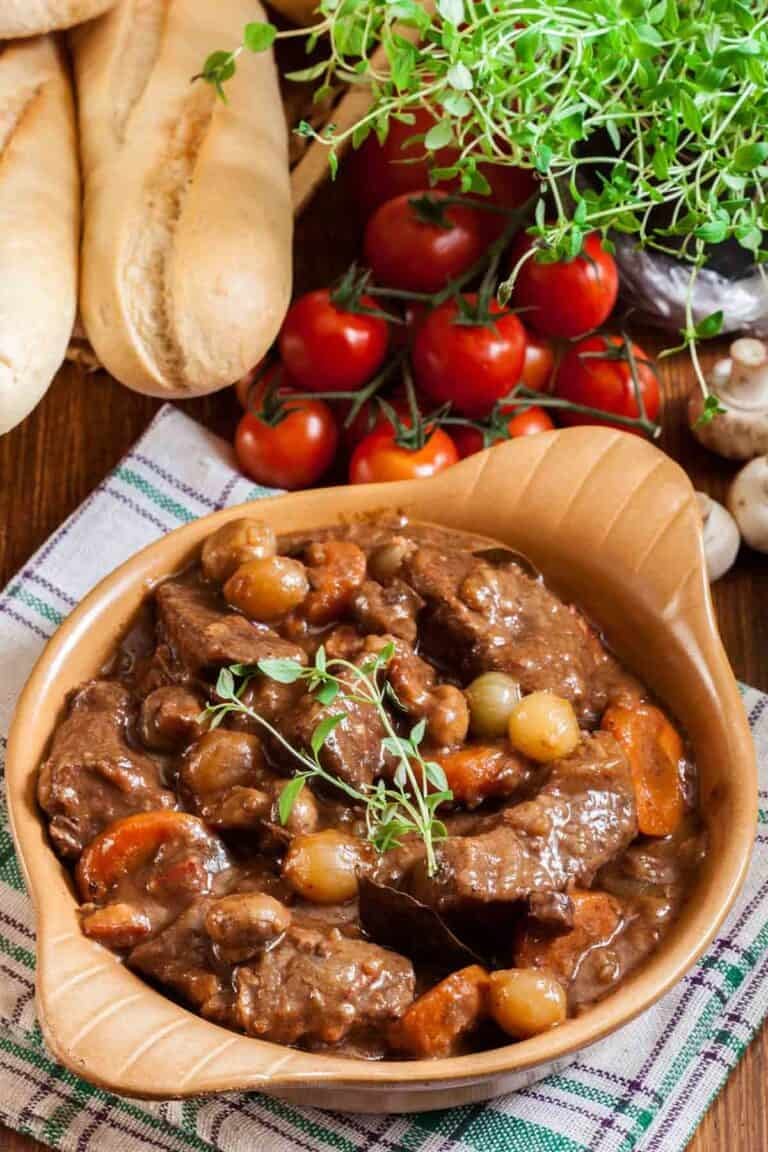 Homemade Julia Child beef bourguignon, bread, tomatoes, and mushrooms.