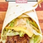 Homemade McDonald's big mac wrap on a wood cutting board.