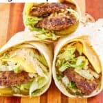 Three homemade McDonald's big mac wraps on a wood board.