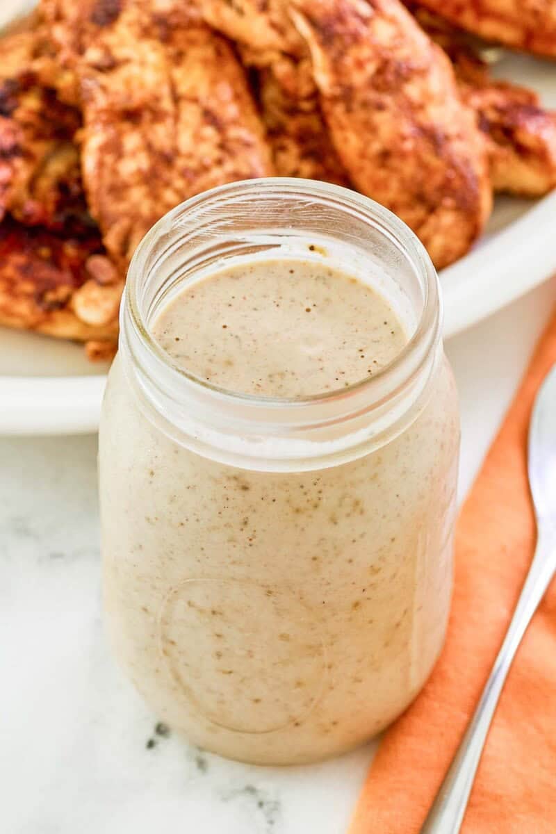 Copycat Popeyes blackened ranch sauce in a glass jar.