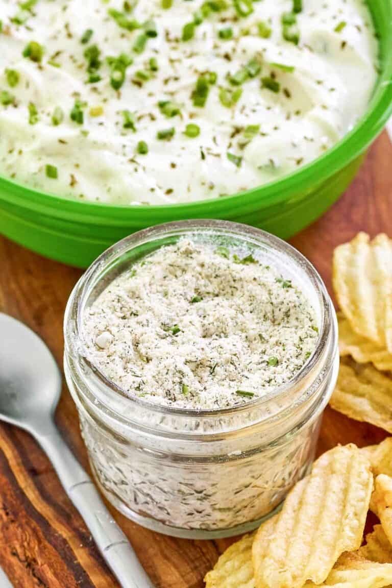 Homemade ranch dressing mix in a mason jar and ranch dip behind it.