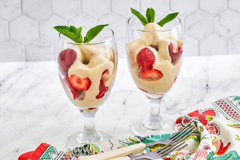 Copycat La Madeleine strawberries romanoff garnished with fresh mint.