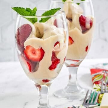 Copycat La Madeleine strawberries romanoff in wine glasses.