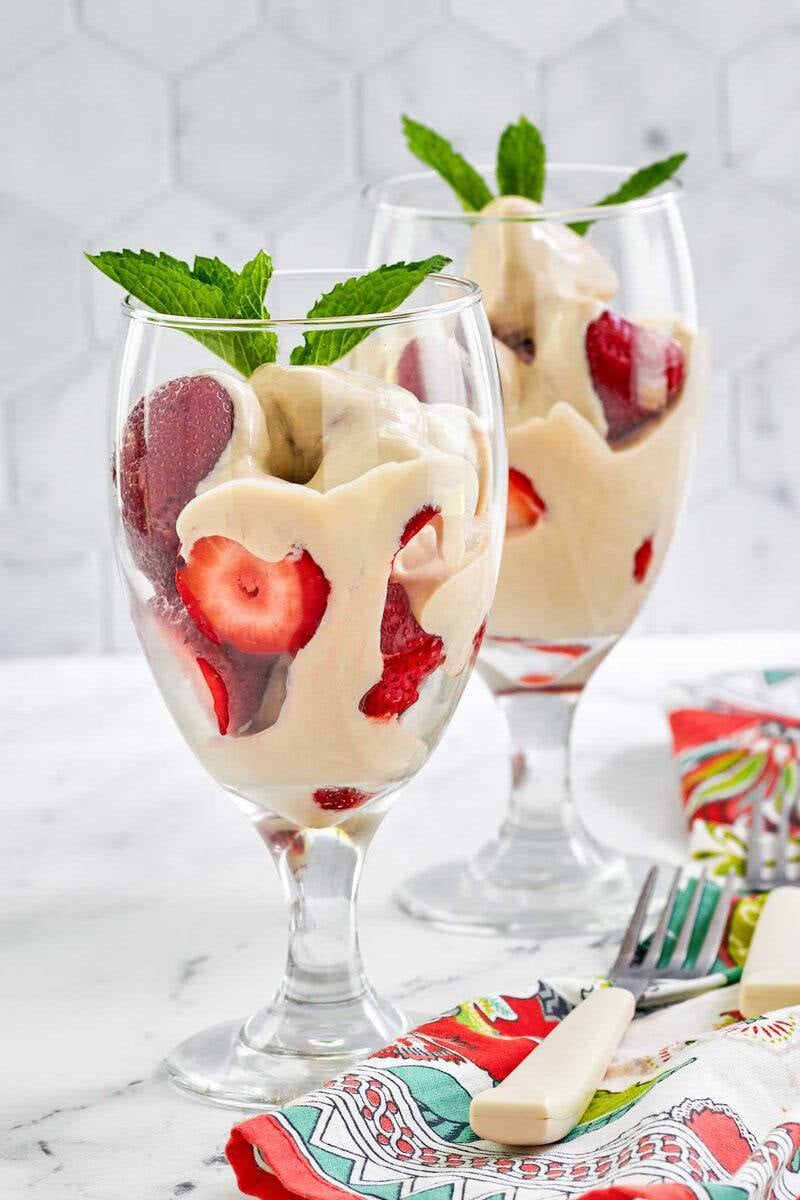 Copycat La Madeleine strawberries romanoff in wine glasses.