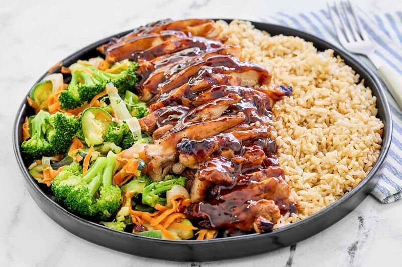 Copycat Teriyaki Madness chicken teriyaki with rice and veggies on a plate.