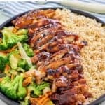 Homemade Teriyaki Madness chicken teriyaki with veggies and rice on a large plate.
