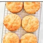 Homemade Bojangles buttermilk biscuits on a wire rack.