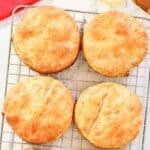 Six homemade Bojangles biscuits on a wire rack.