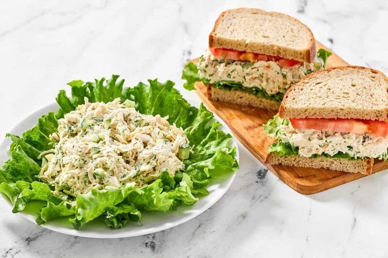 Copycat chicken salad chick dill-icious chicken salad on lettuce and in a sandwich.