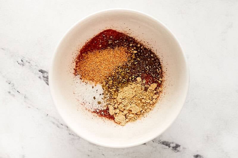 Homemade chicken taco seasoning ingredients in a small bowl.