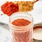 Homemade chicken taco seasoning mix in a small glass jar.