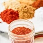 Homemade chicken taco seasoning in a small glass jar.