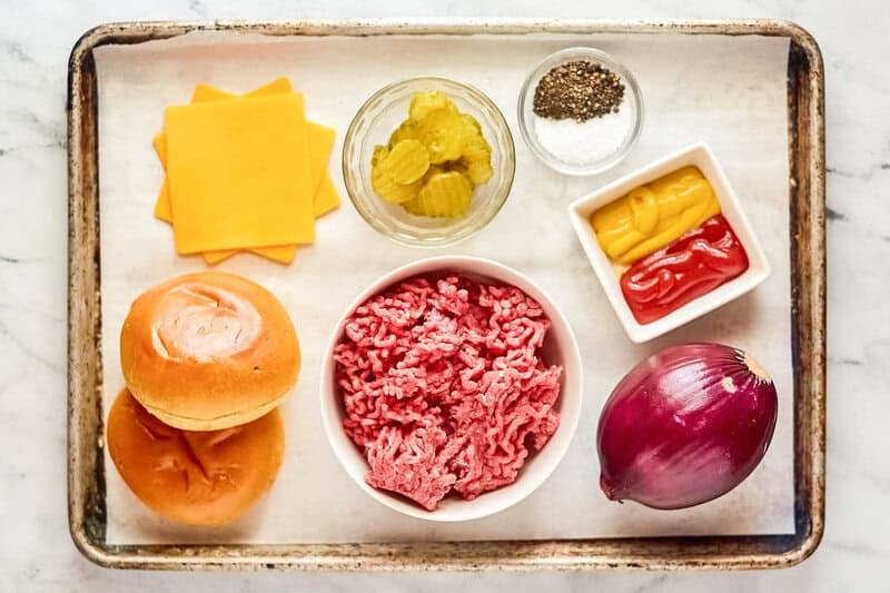 Copycat Chili's big qp burger ingredients on a tray.