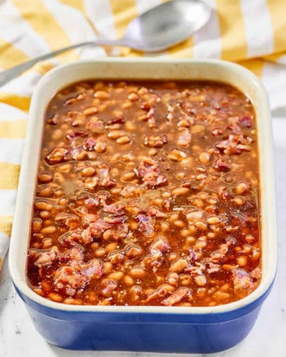 Copycat Durgin Park Boston baked beans and a serving spoon behind it.